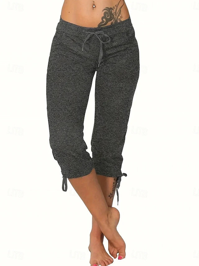 Slim silhouette with stretch fabric, practical drawstring and pockets, casual street style for spring and summer.