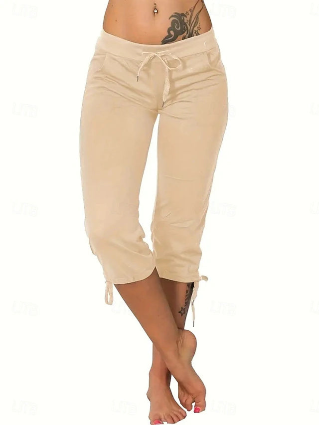 Slim silhouette with stretch fabric, practical drawstring and pockets, casual street style for spring and summer.